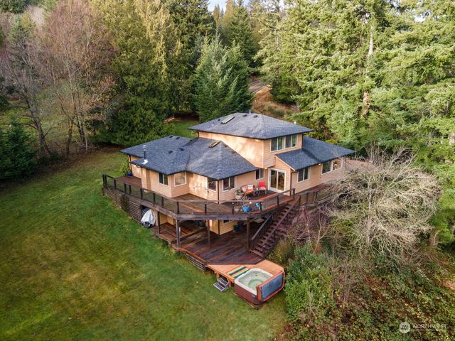 an aerial view of a house with garden space and trees