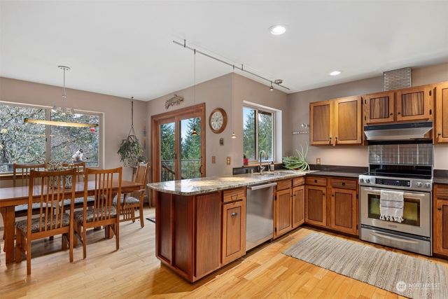 a kitchen with stainless steel appliances granite countertop a stove and a sink