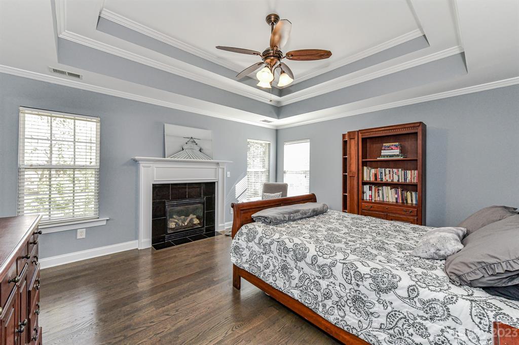 21311 Summerbrook Drive Cornelius, NC 28031 - Photo 14 of 28 a bedroom with a bed and a fireplace