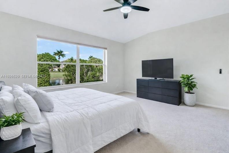 22065 Palm Grass Drive Boca Raton, FL 33428 - Photo 15 of 46 a bedroom with a bed potted plant and a window
