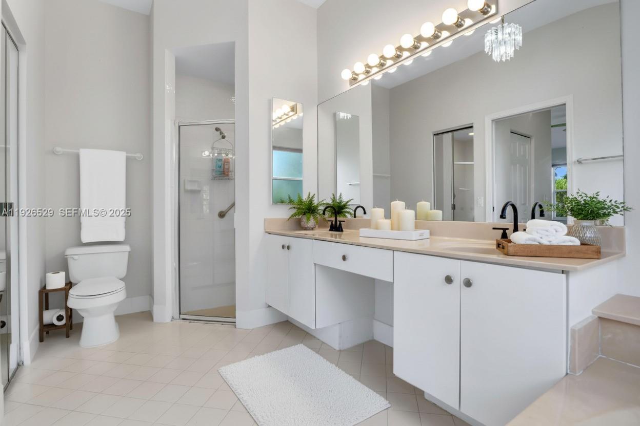 22065 Palm Grass Drive Boca Raton, FL 33428 - Photo 18 of 46 a spacious bathroom with a double vanity sink mirror and toilet