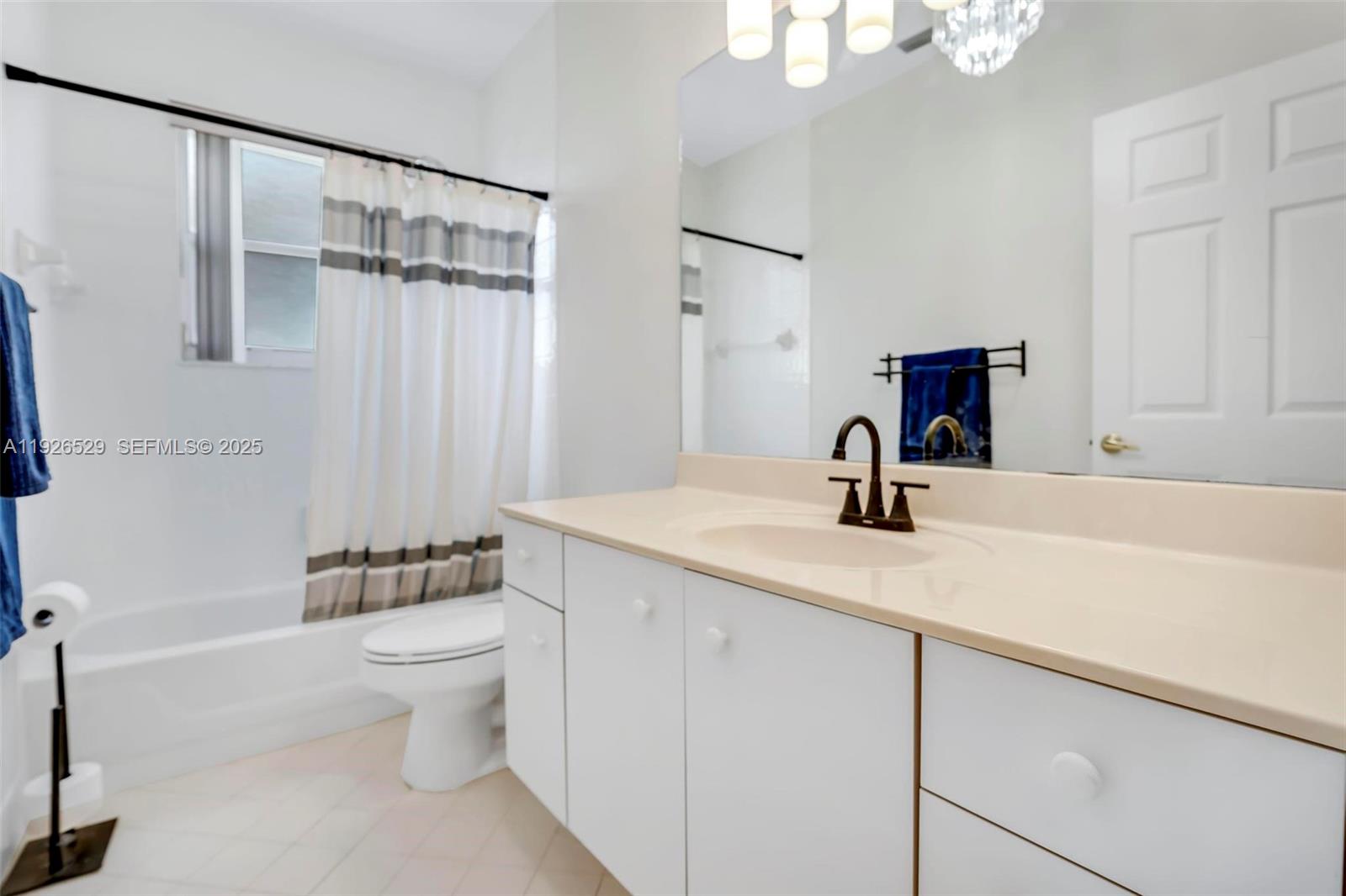 22065 Palm Grass Drive Boca Raton, FL 33428 - Photo 22 of 46 a bathroom with a sink a toilet and shower