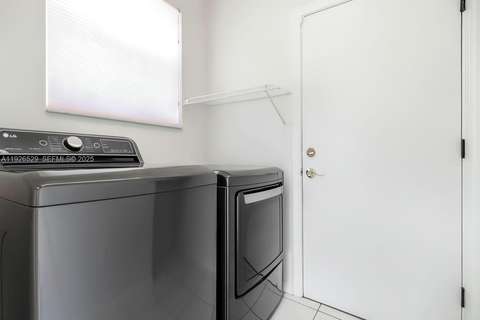 22065 Palm Grass Drive Boca Raton, FL 33428 - Photo 25 of 46 a utility room with dryer and washer