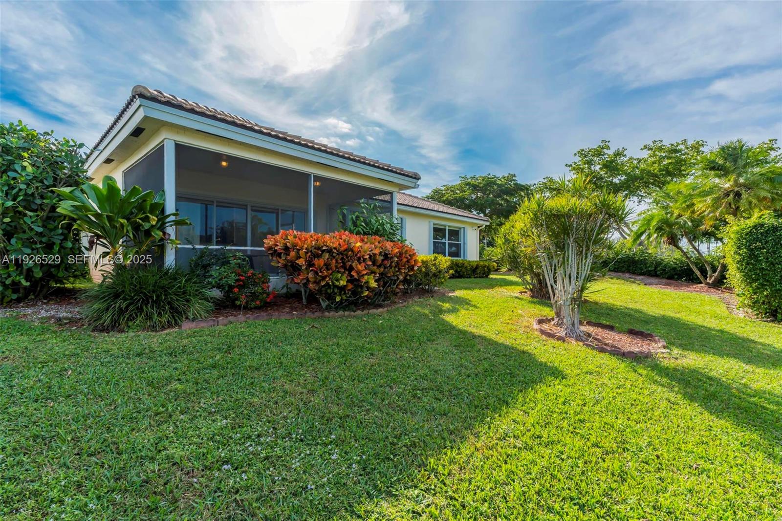 22065 Palm Grass Drive Boca Raton, FL 33428 - Photo 29 of 46 a front view of a house with garden