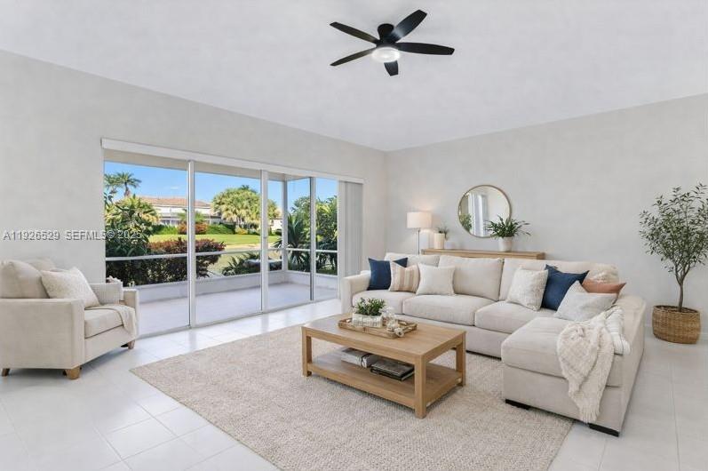 22065 Palm Grass Drive Boca Raton, FL 33428 - Photo 4 of 46 a living room with furniture and a floor to ceiling window