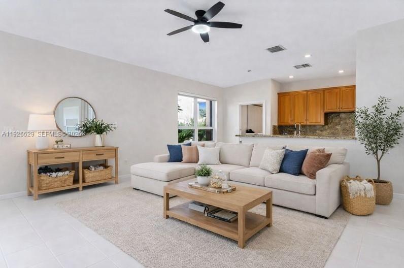 22065 Palm Grass Drive Boca Raton, FL 33428 - Photo 5 of 46 a living room with furniture a fireplace and a window