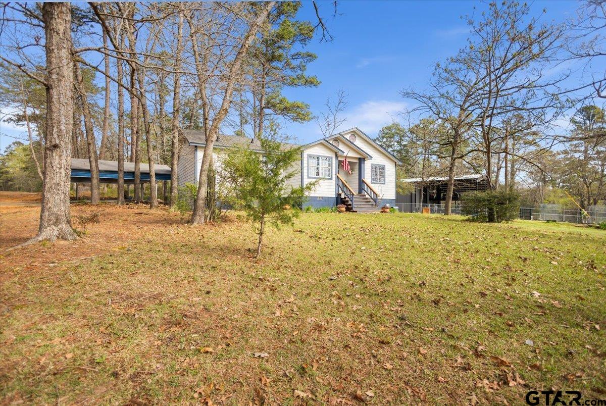 289 Acapulco Road Jefferson, TX 75657 - Photo 25 of 30 a view of a yard with a tree