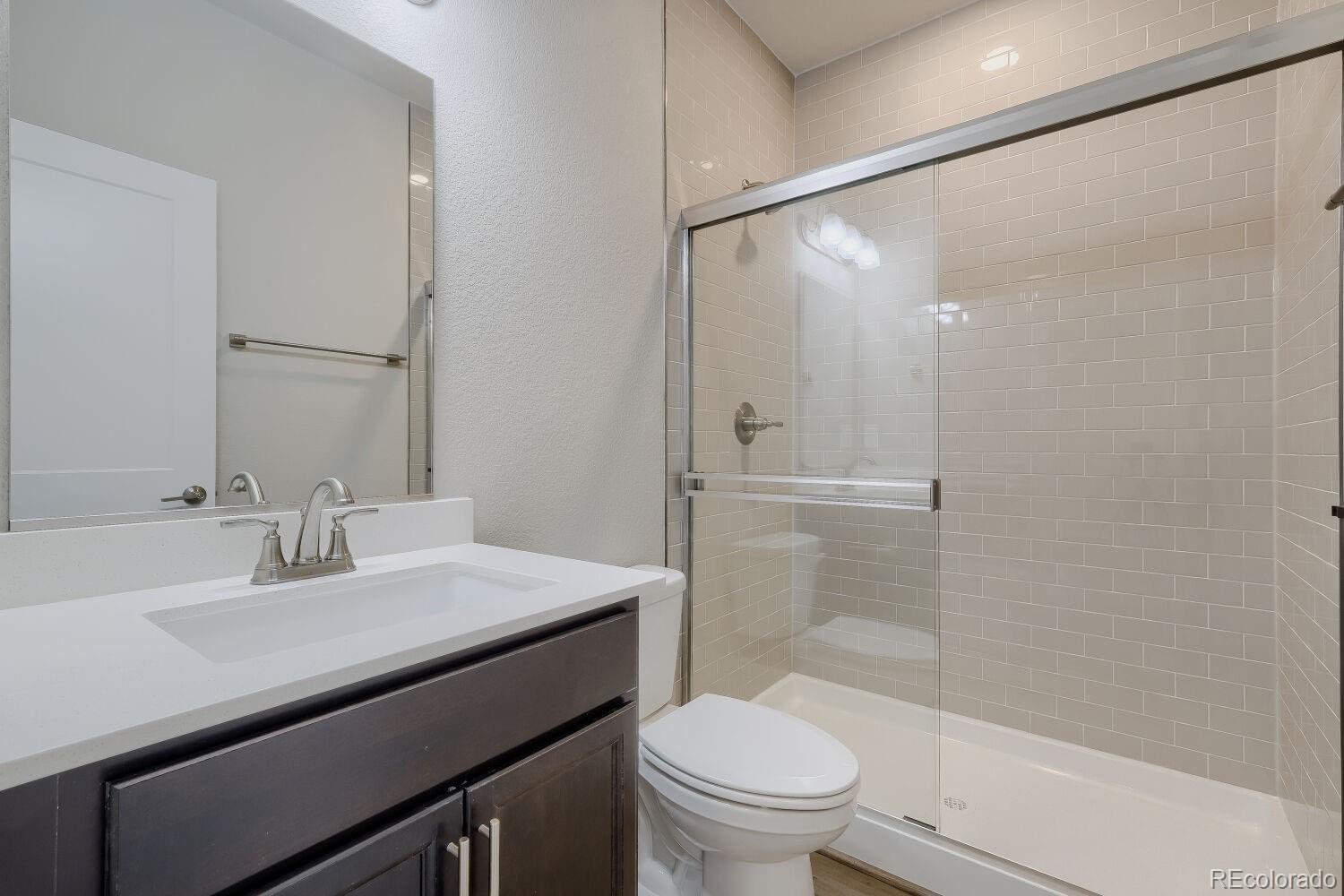 471 Atchison Way Calhan, CO 80808 - Photo 18 of 31 a bathroom with a sink a toilet and shower