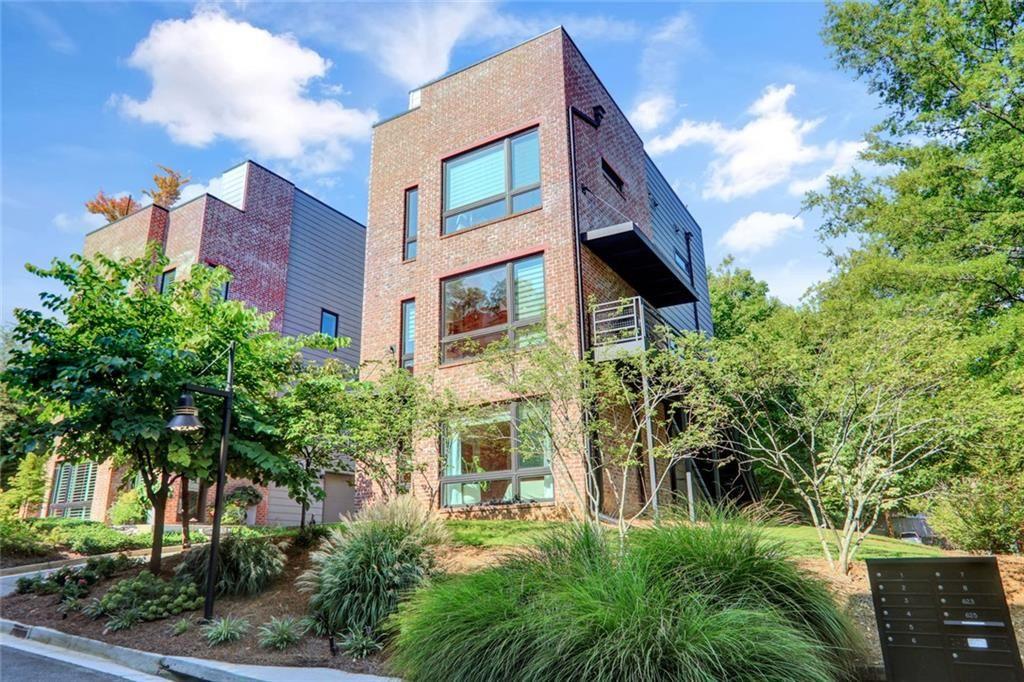 a view of a multi story residential apartment building with a yard
