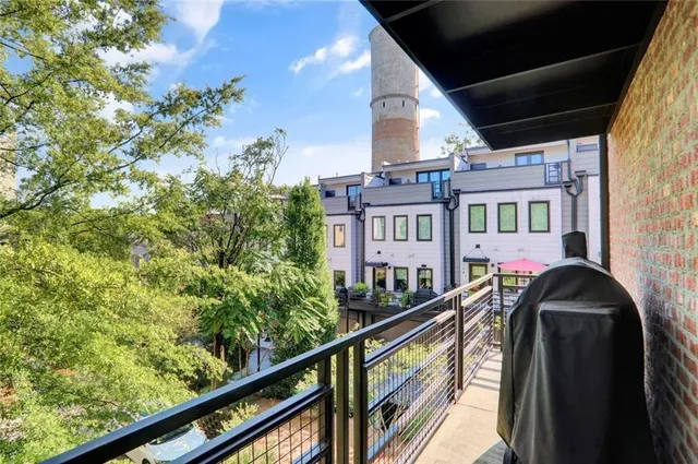a bedroom with a large bed and a painting on the wall