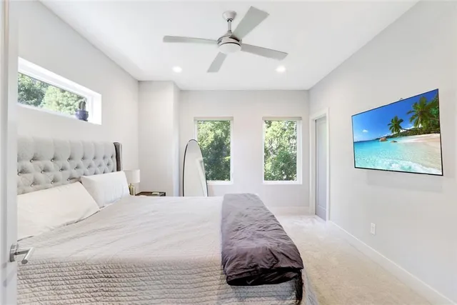 a bedroom with a large bed and a window