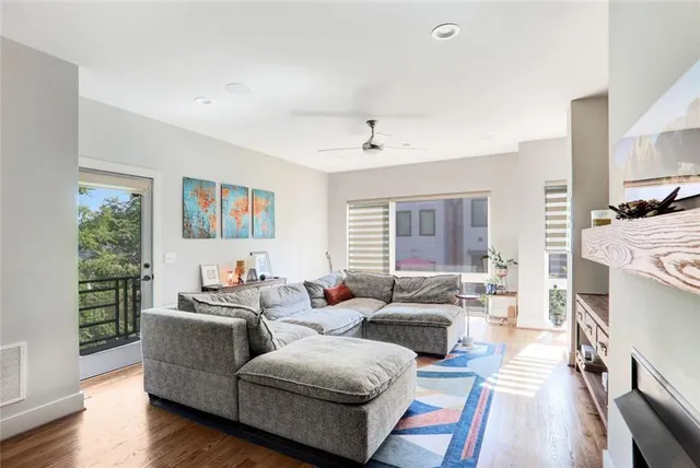 a bedroom with a bed and large window with chair