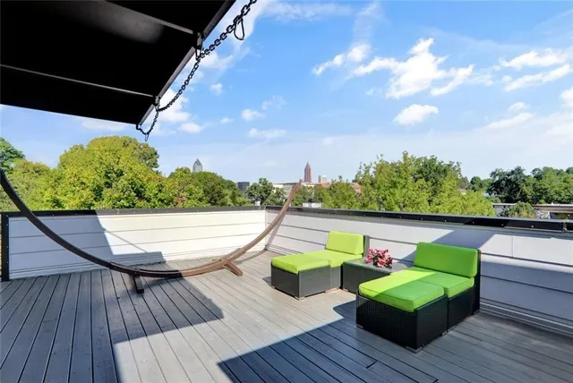 a view of sitting area in balcony with wooden floor