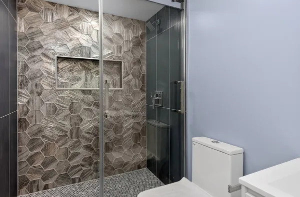 a bathroom with a toilet and a shower