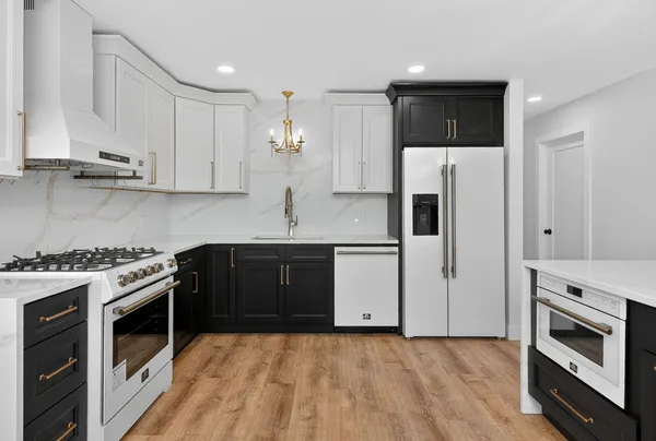 a kitchen with stainless steel appliances granite countertop a stove a sink and a refrigerator