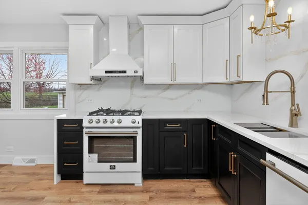 a kitchen with stainless steel appliances granite countertop a stove and a refrigerator