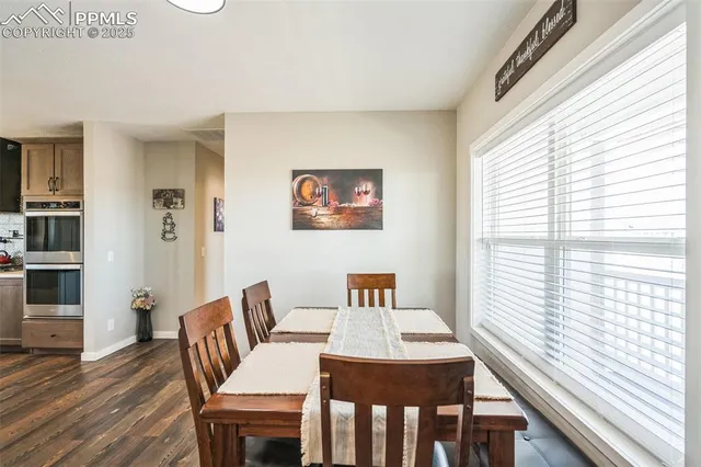 a view of a dining room with furniture window and wooden floor