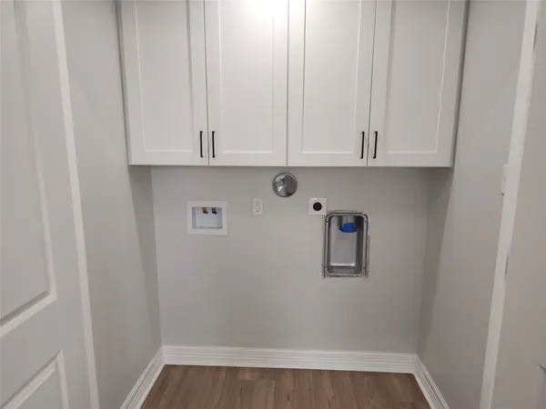 a view of storage and utility room with wooden floor