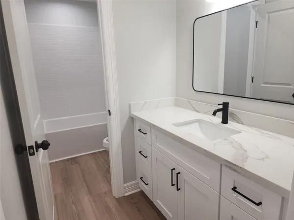 a bathroom with a sink a mirror and shower