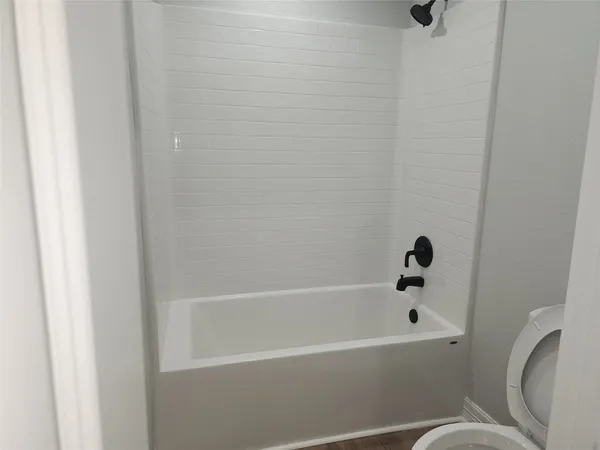 a bathroom with a bathtub and toilet