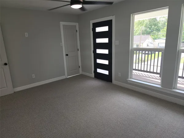 an empty room with windows and closet