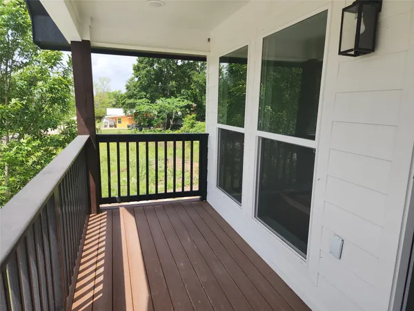 a view of a balcony with wooden floor