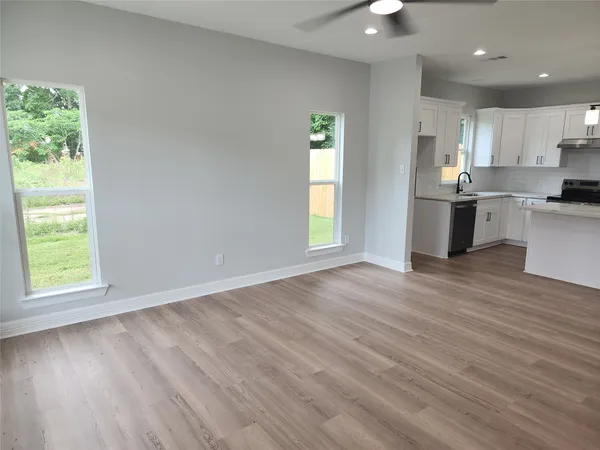 a view of kitchen with wooden floor electronic appliances and window