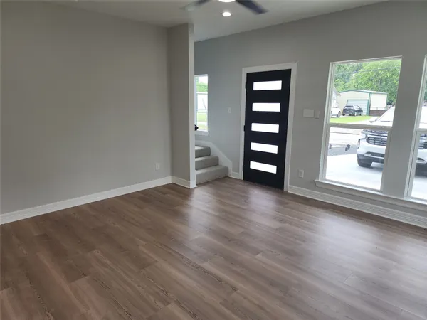 a view of wooden floor and windows in a room