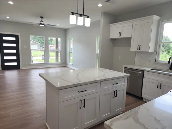 a kitchen with a sink stove and cabinets