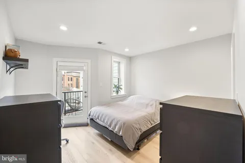 a spacious bedroom with a bed and a window