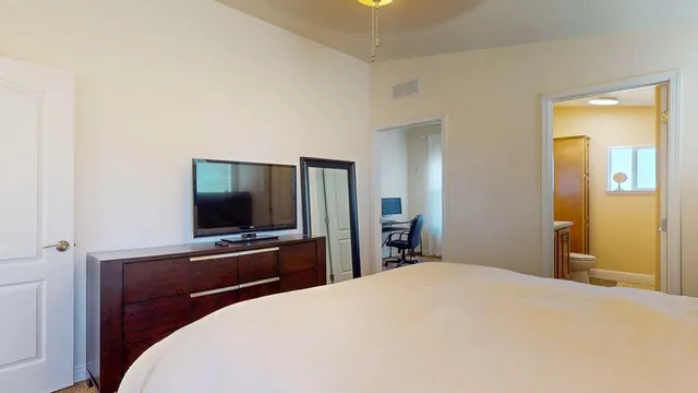 a bedroom with a large bed and a window