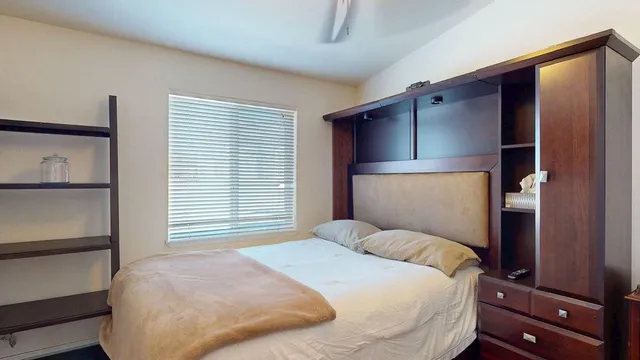 a bedroom with a bed and a window