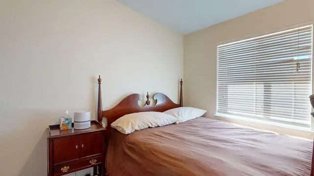a view of a dining room with furniture a rug and a large window