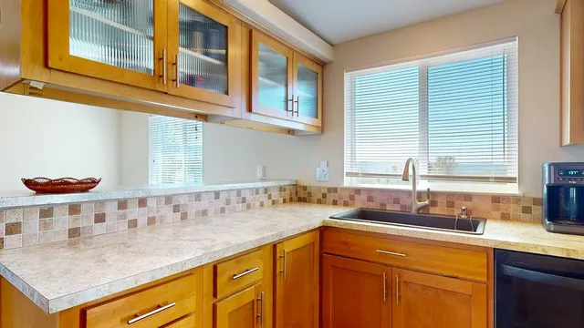 a kitchen with stainless steel appliances granite countertop a sink and cabinets