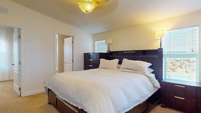 a bathroom with a granite countertop sink toilet and mirror