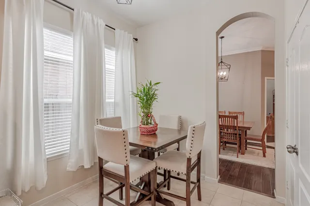 a dining room with furniture and window