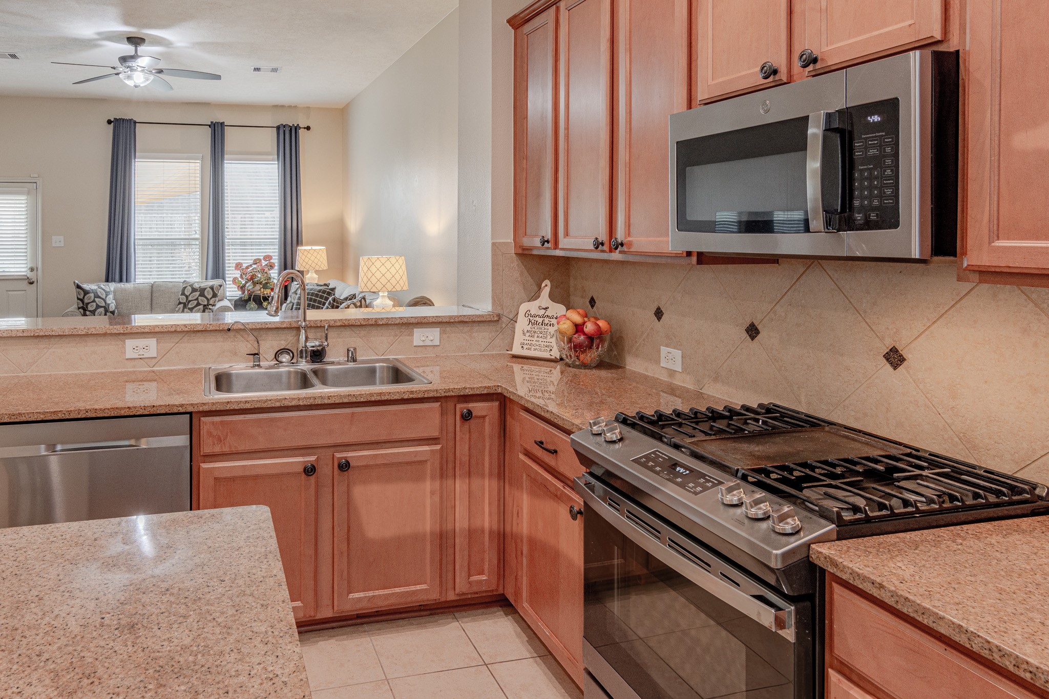 2954 Smokey Forest Lane Spring, TX 77386 - Photo 18 of 40 a kitchen with stainless steel appliances granite countertop a stove microwave and sink