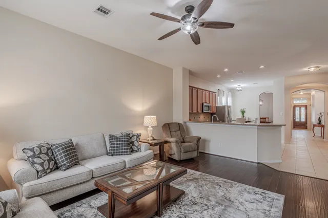 a living room with furniture and kitchen view