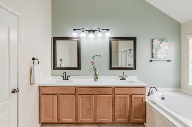 a bathroom with a double vanity sink and a mirror