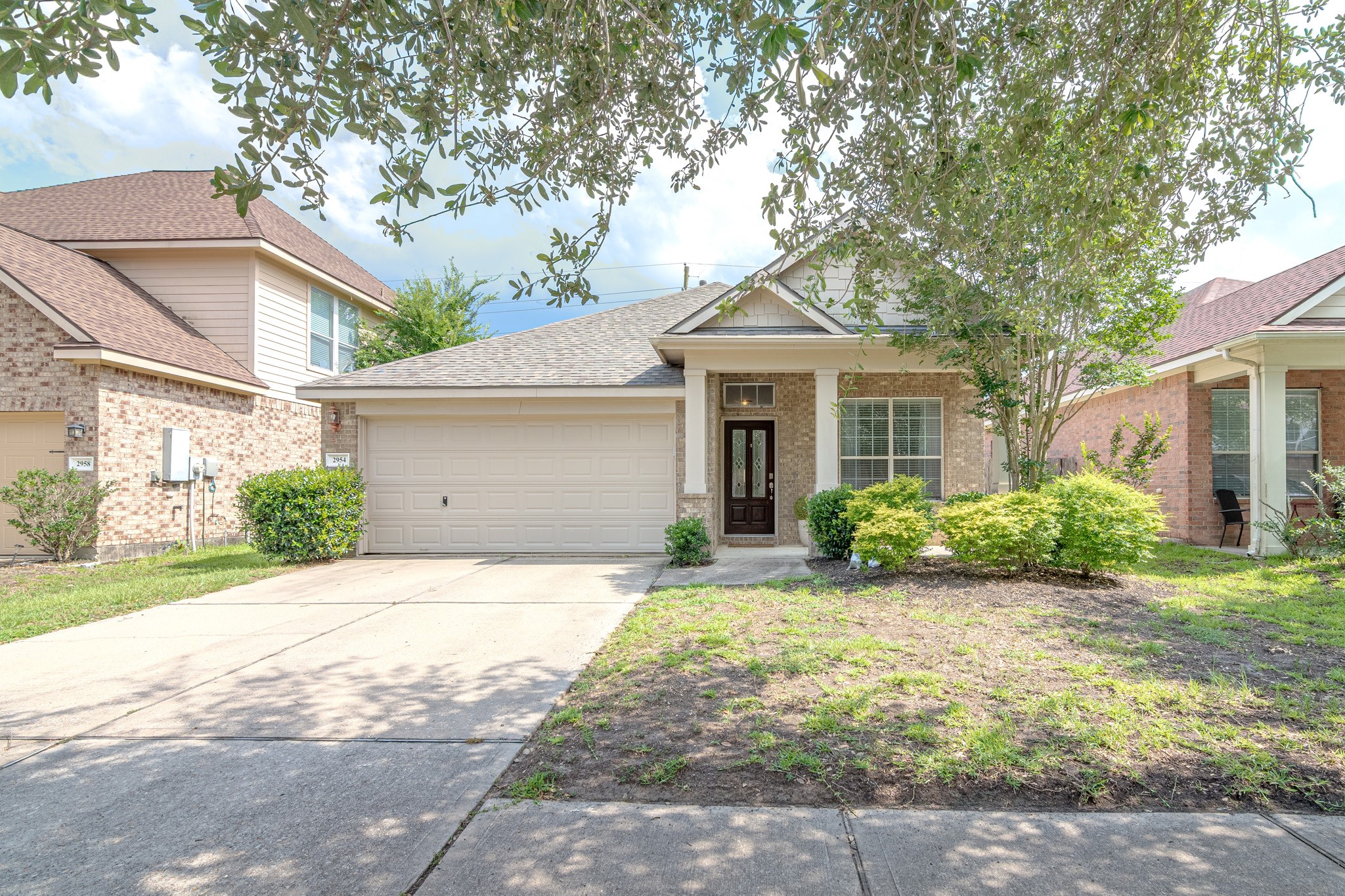 2954 Smokey Forest Lane Spring, TX 77386 - Photo 3 of 40 a front view of a house with a yard and potted plants