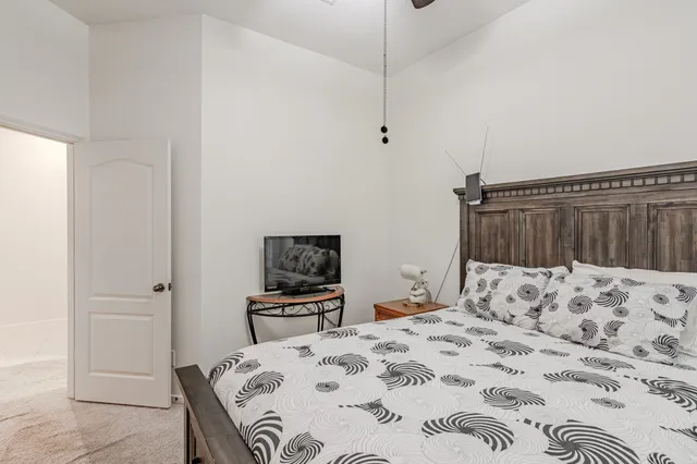 a bedroom with a bed and a dresser