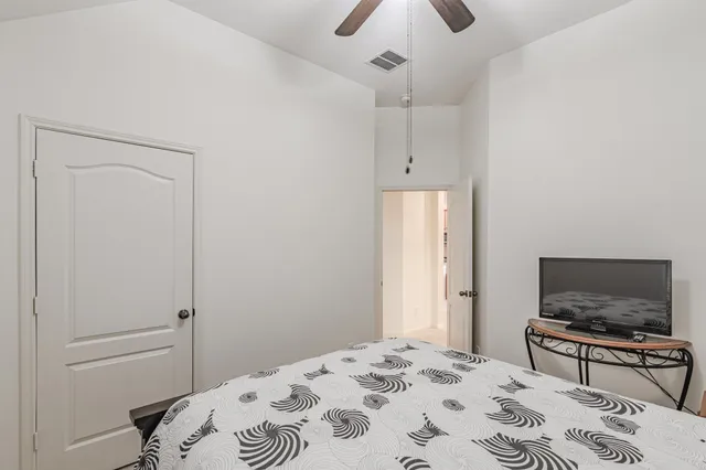 a bedroom with a bed and a television