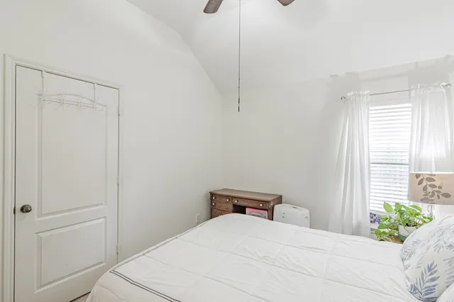 a bedroom with a bed and a window