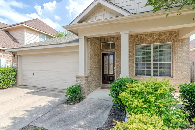 a view of a house with potted plants