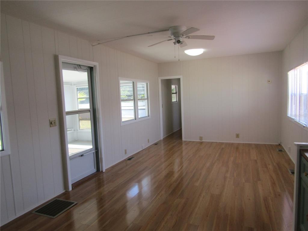 721 Roma Road Venice, FL 34285 - Photo 4 of 20 wooden floor in an empty room with a window