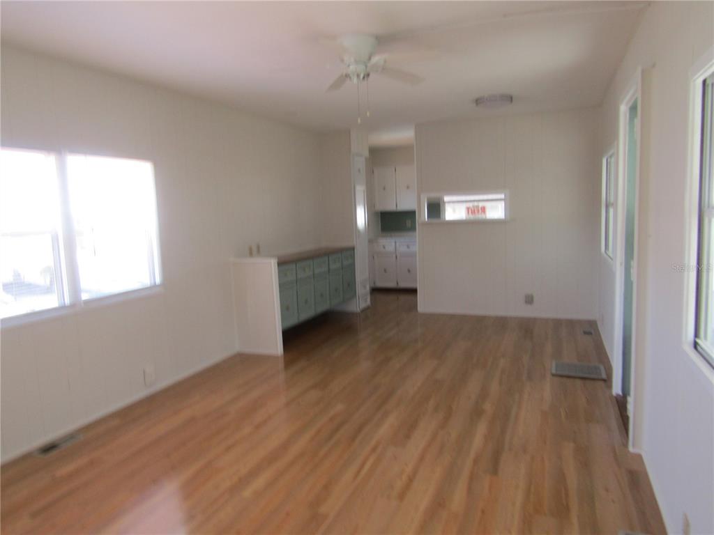 721 Roma Road Venice, FL 34285 - Photo 5 of 20 an empty room with wooden floor and windows