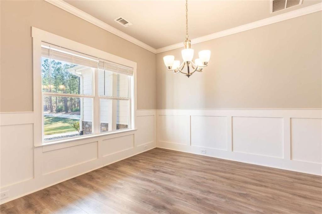35 Hawthorn Lane Covington, GA 30014 - Photo 13 of 38 an empty room with wooden floor chandelier and windows