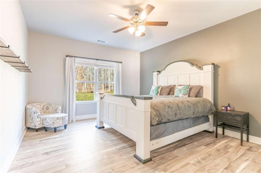 35 Hawthorn Lane Covington, GA 30014 - Photo 15 of 38 a bedroom with a bed and a chandelier