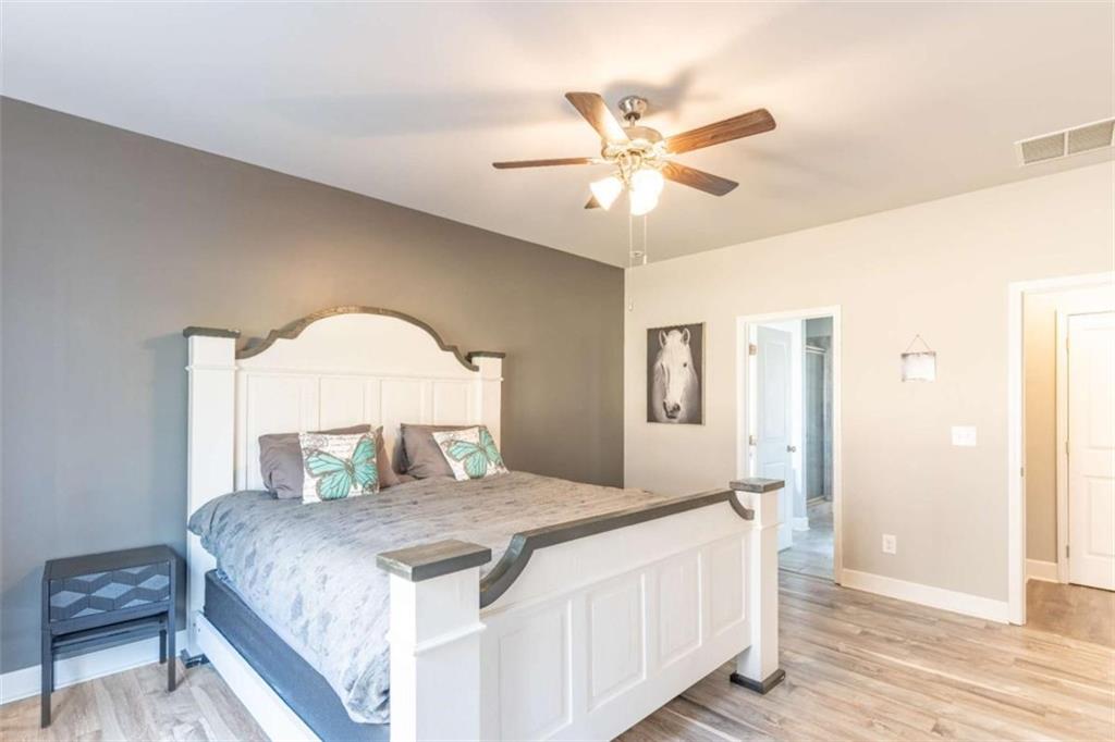 35 Hawthorn Lane Covington, GA 30014 - Photo 16 of 38 a bedroom with a large bed and a chandelier