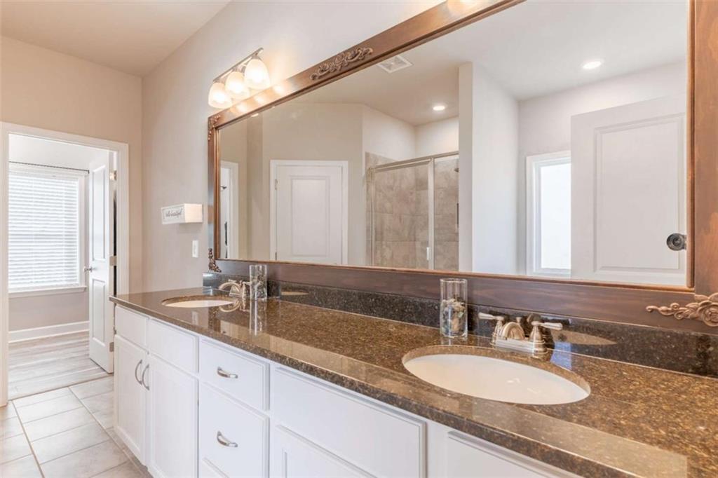 35 Hawthorn Lane Covington, GA 30014 - Photo 18 of 38 a bathroom with double vanity sinks and a mirror